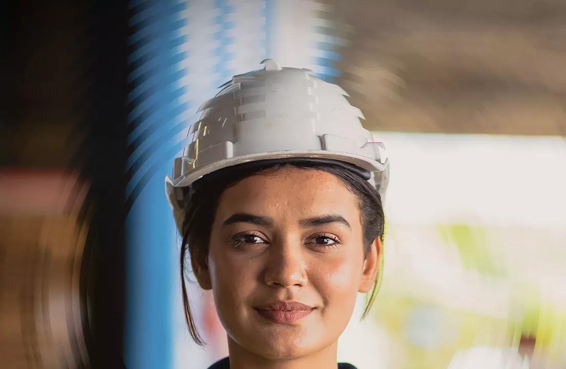 Human capital management research image of worker with hard hat.
