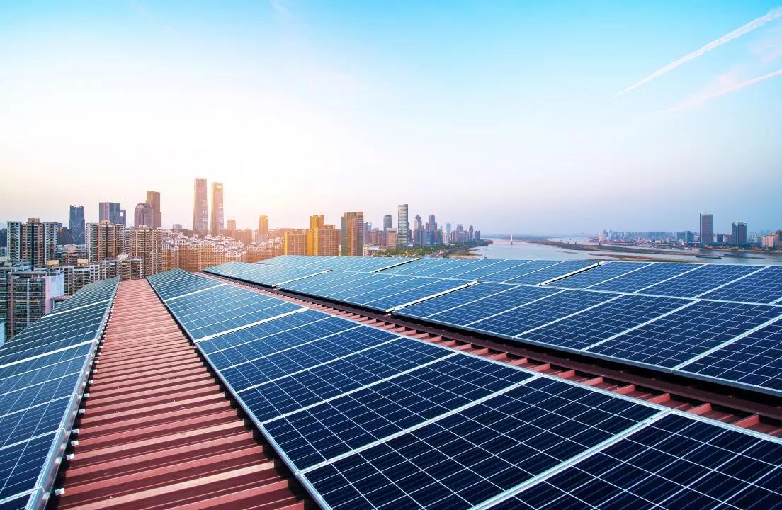 Image of solar panels and city skyline